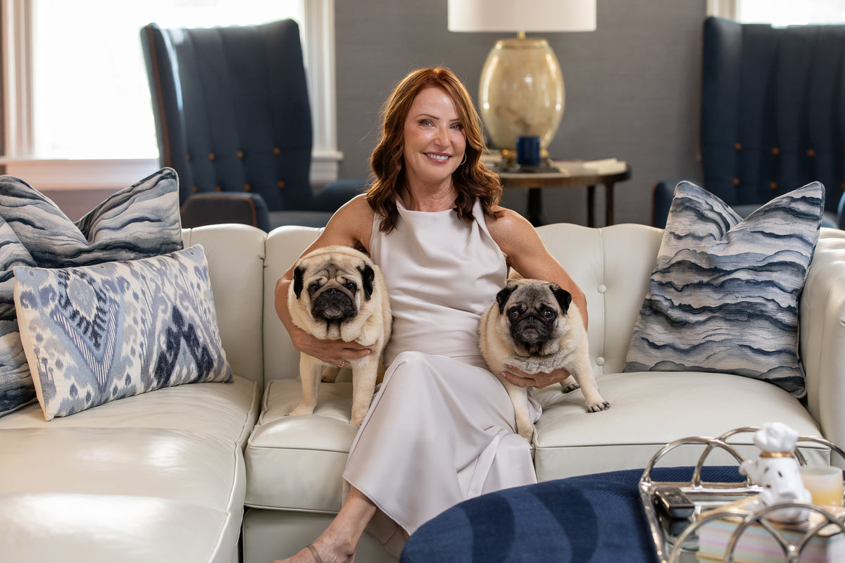 Jennifer Sherak at home with her two pugs
